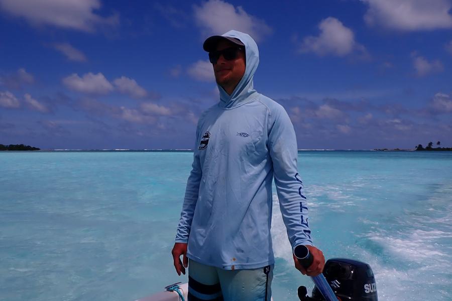 Researcher Jack Egerton on a boat in a tropical sea
