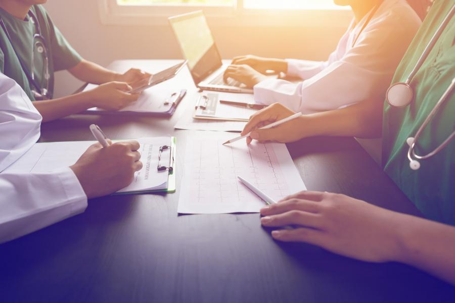 Image of a group of clinicians working around a table