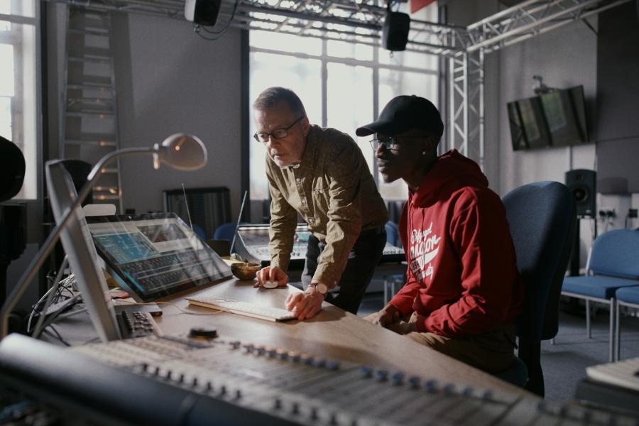 Professor Andrew Lewis in the music studios with a student 