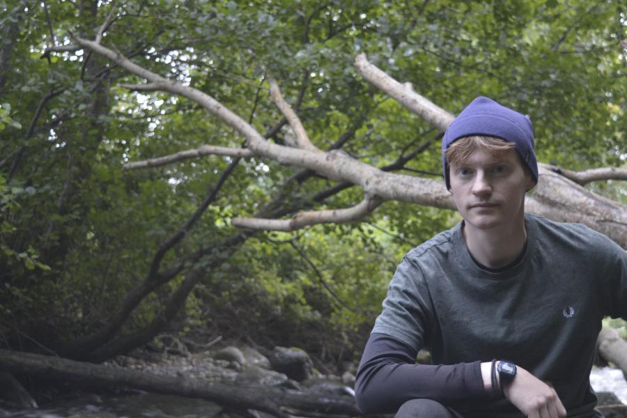 Researcher Charlie Gregory sitting by a tree