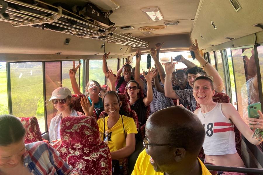 Forestry students laughing and smiling on a bus