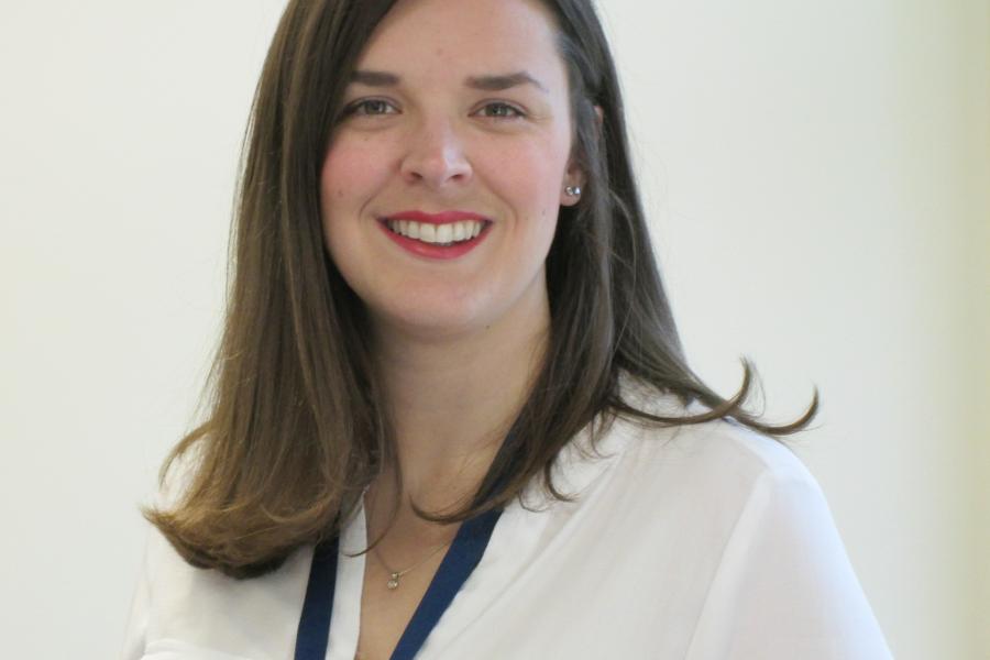 Dr Kat Ford wearing a white blouse, smiling at the camera