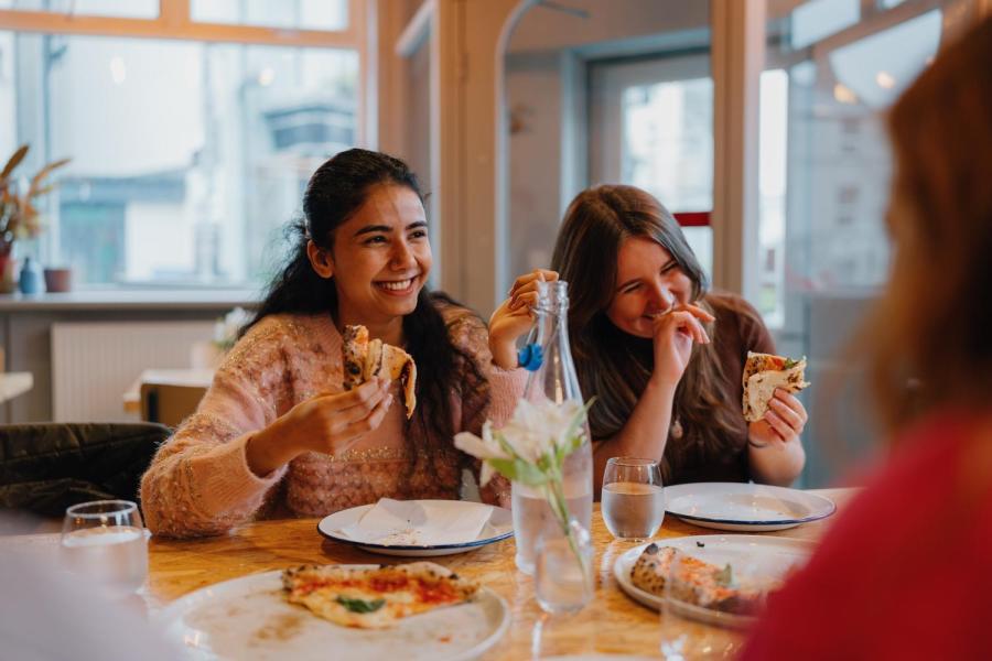 Students chatting and laughing over a meal