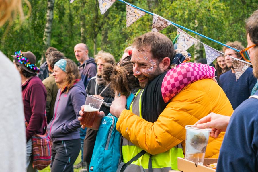A couple embracing during a festival in a field