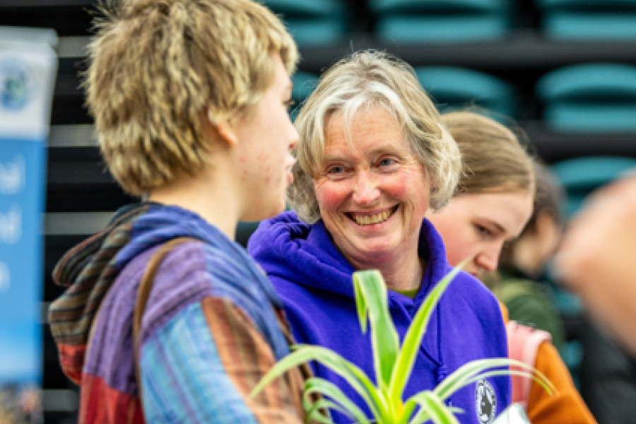 Smiling lady talking to a student