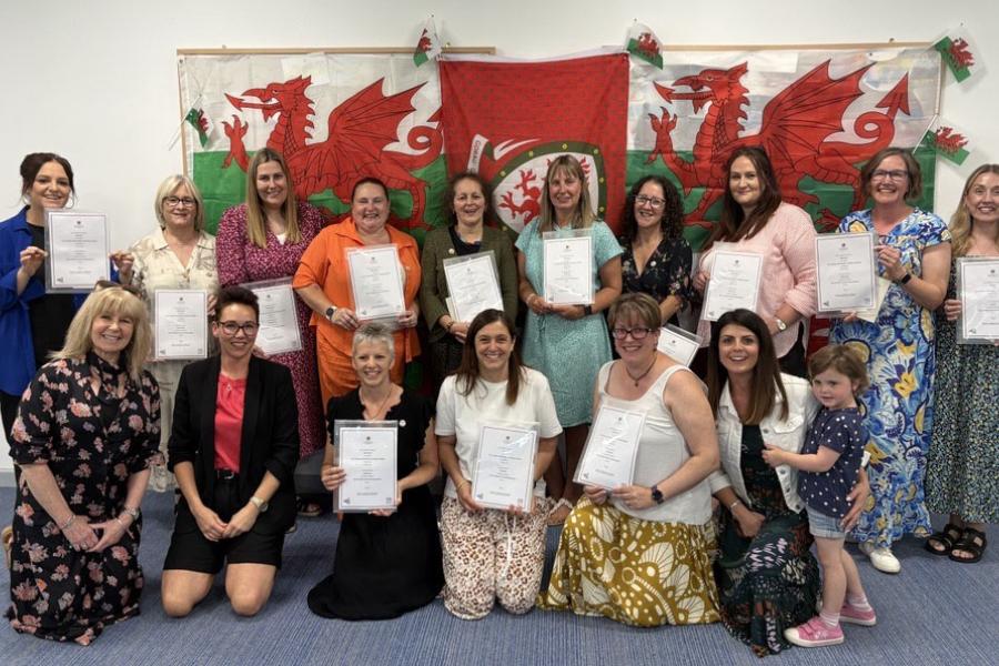 A group of women standing and holding certificates