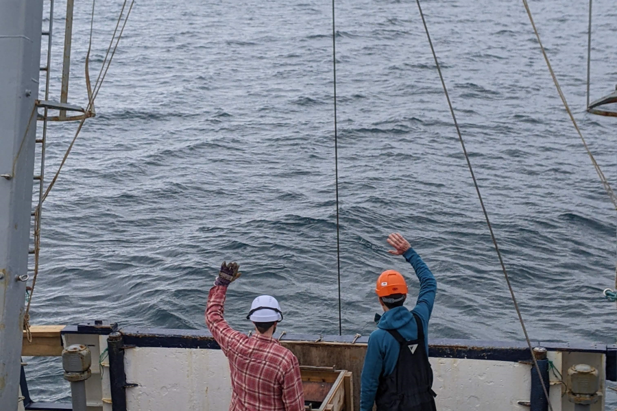 Bangor University staff onboard the research vessel Prince Madog wave to a commercial fishing vessel involved in the project during the experiment. 