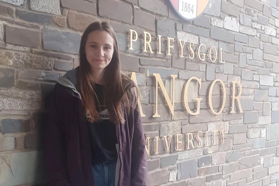 Image of 3rd year Law Student standing in front of the BU sign