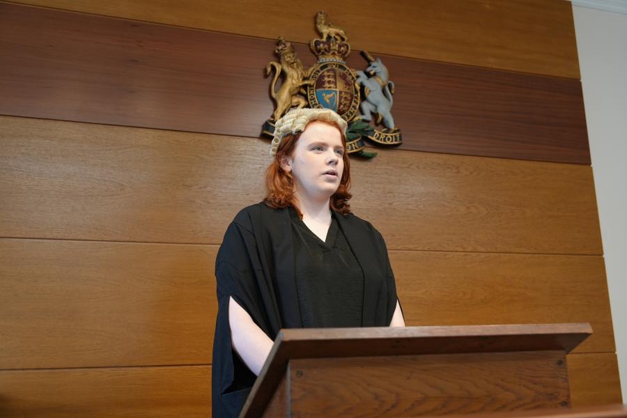 Student in the Moot Court room looking away from the camera