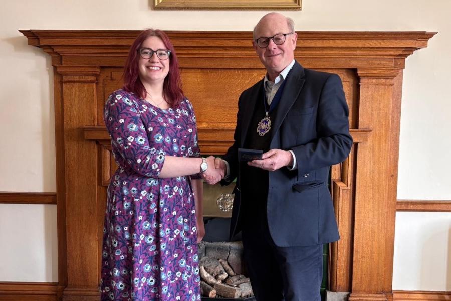 Rebecca Day shaking hands with Master Draper Patrick Beddows