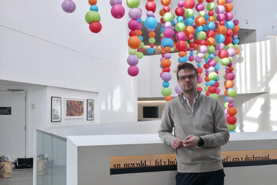 Matt Coles with art installation in the main atrium to celebrate neurodiversity week 