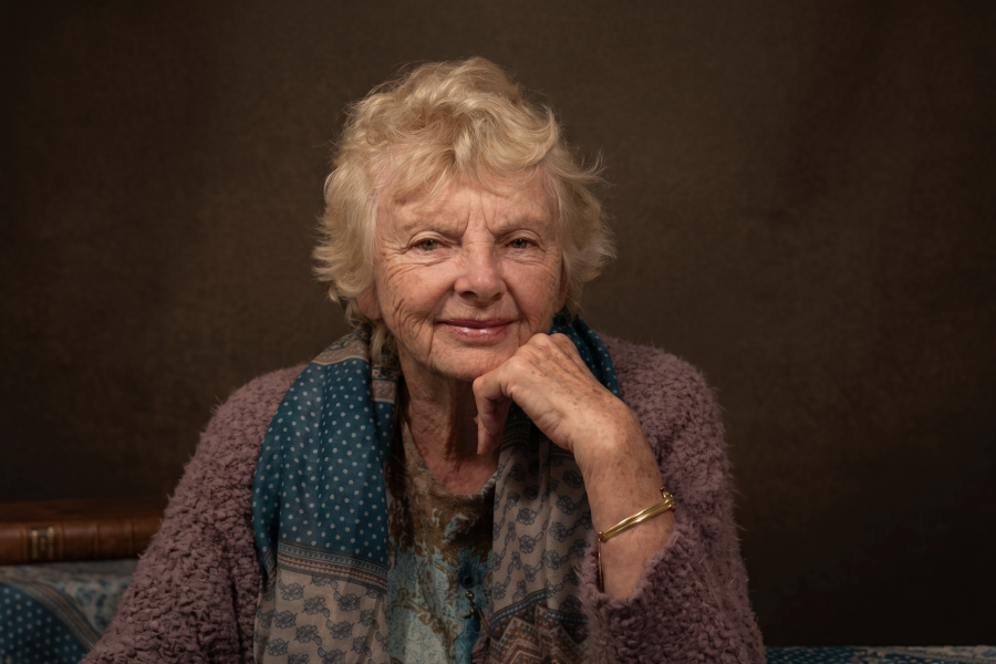 profile picture of Dr Mabel Tannahill with her head resting on arm - with subtle smile and glow