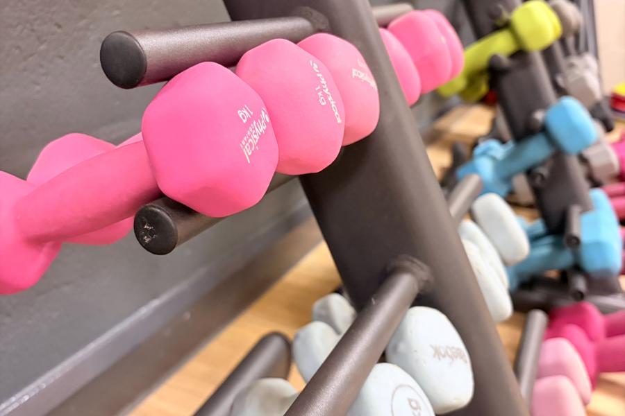 some dumbells on a rack