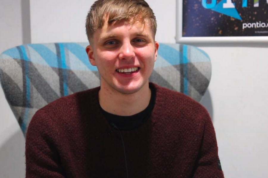 Student George smiling at the camera