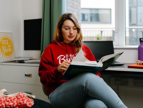 A student sits reading in St Mary's