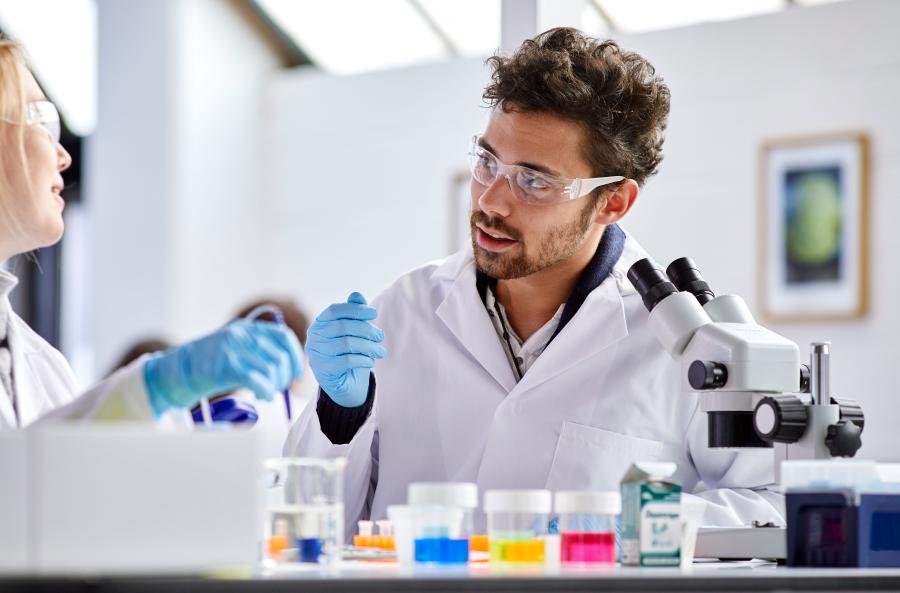 A couple of students discussing their work in a lab