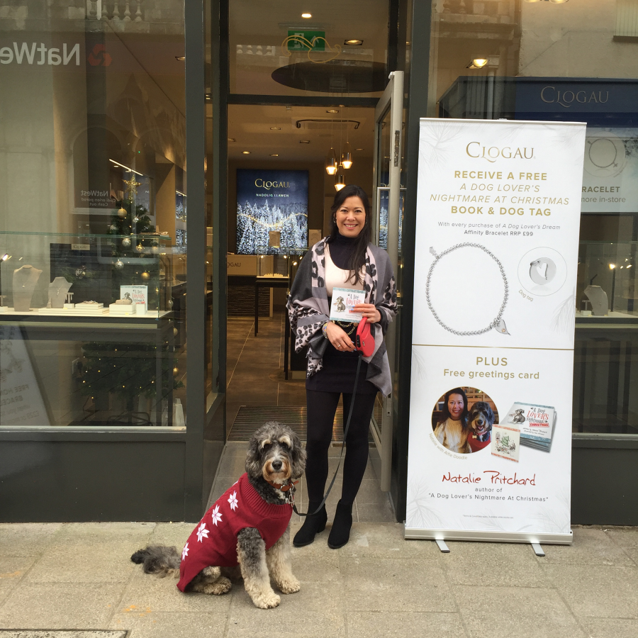 Woman with dog outside shop