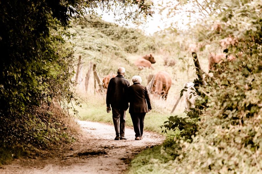 An older couple walking in countryside