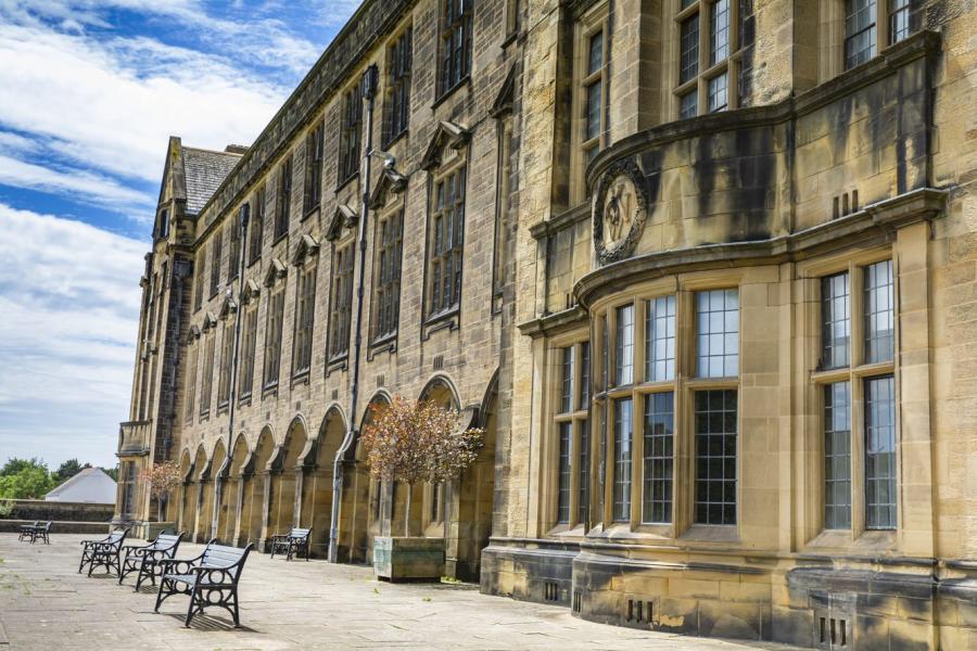 Bangor University's Main Arts building with benches in front