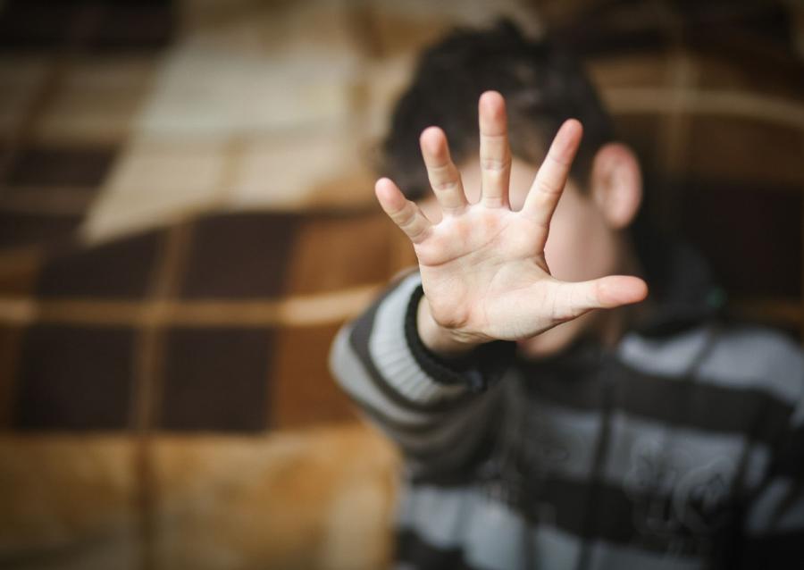 Child with his hand up to the camera