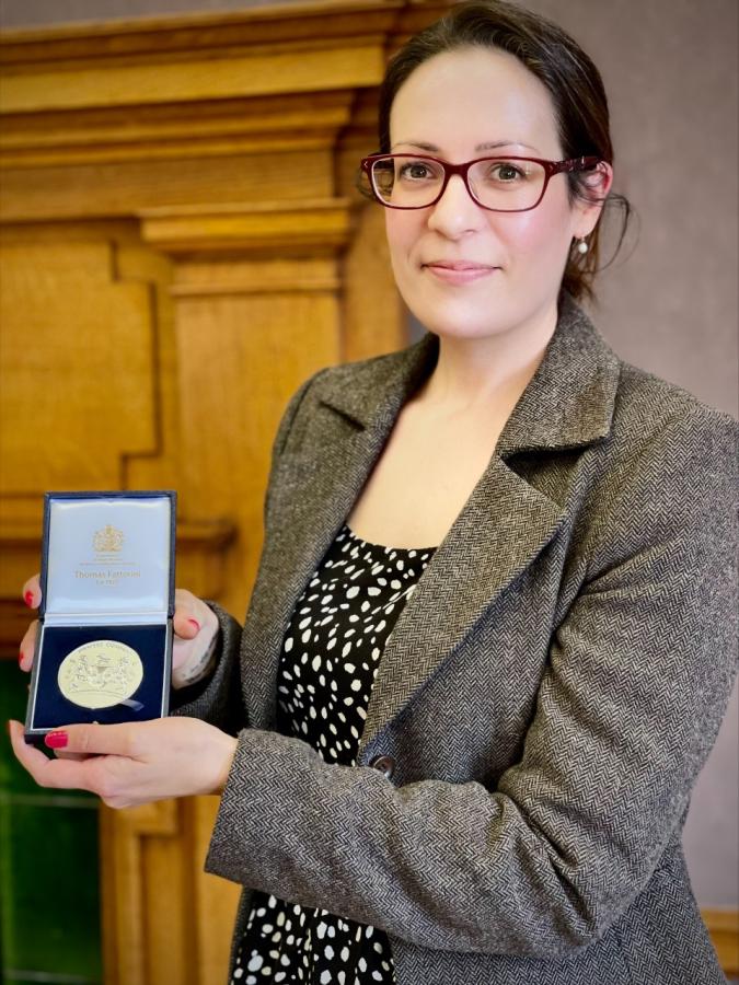 Beverly Pickard-Jones holding her silver Drapers medal