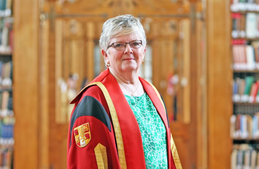 Menai Williams in Bangor University gown in Shankland Reading Room