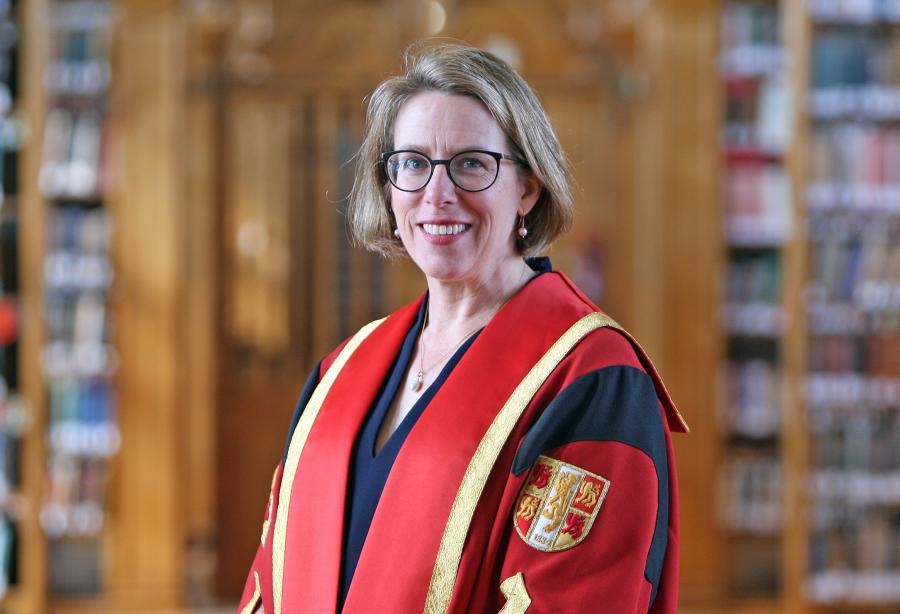 Dr Rebecca Heaton in Bangor University gown in the Shankland Reading Room