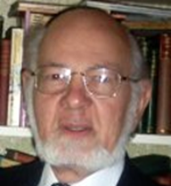 Image of Dr. Roger Simpson in front of bookshelf
