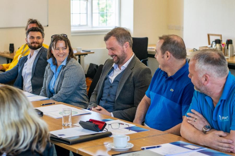 staff around a table discussing wisdom labs project