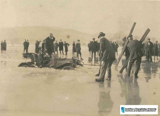 Photo of a partially sunken car on a frozen Llyn Tegid 