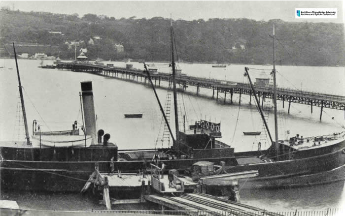 Photo of a ship docked at a jetty next to Bangor Pier