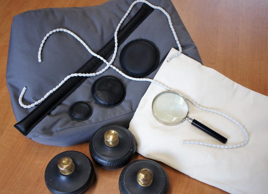 Photo of equipment used in reading room, cushions, weights magnifying glass