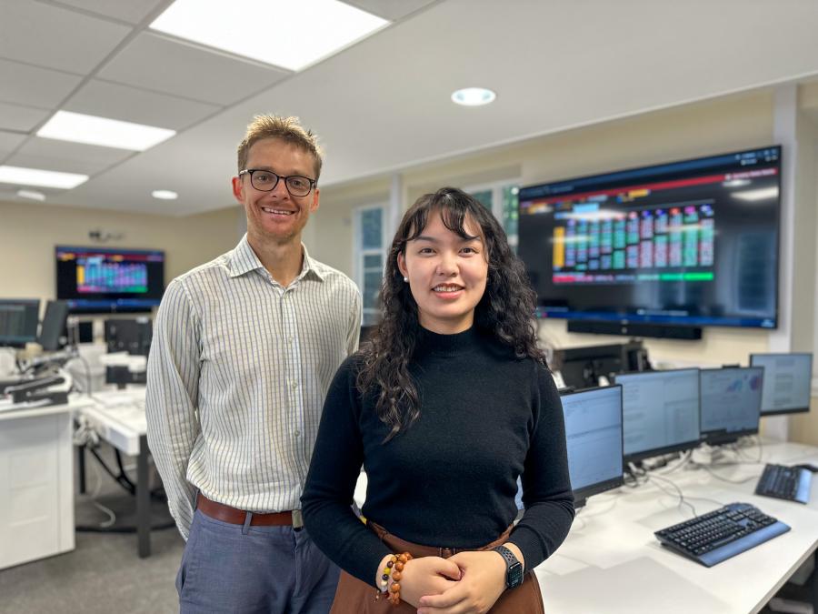 Two people standing on a Trading Room floor