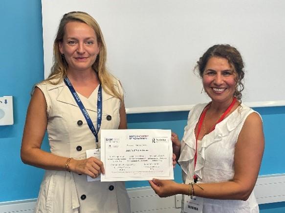 Two women holding a certificate