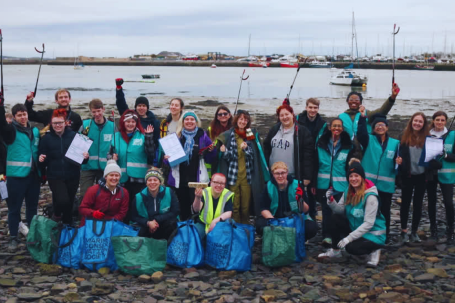 Volunteering community during a beach clean in Bangor