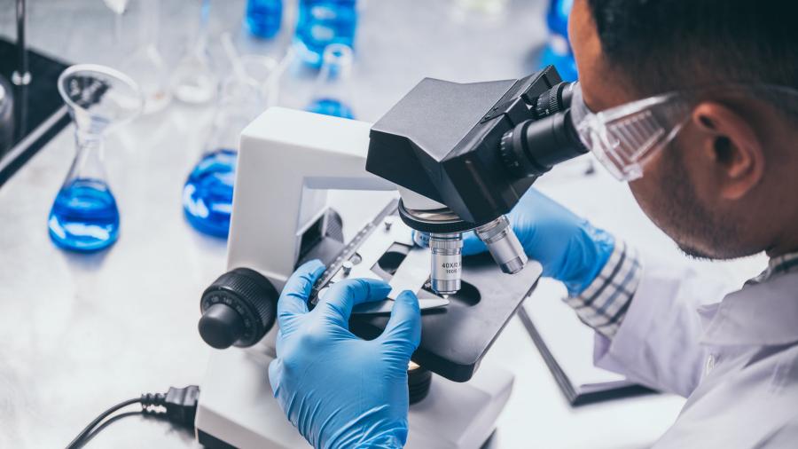 Medical Scientist using a Microscope
