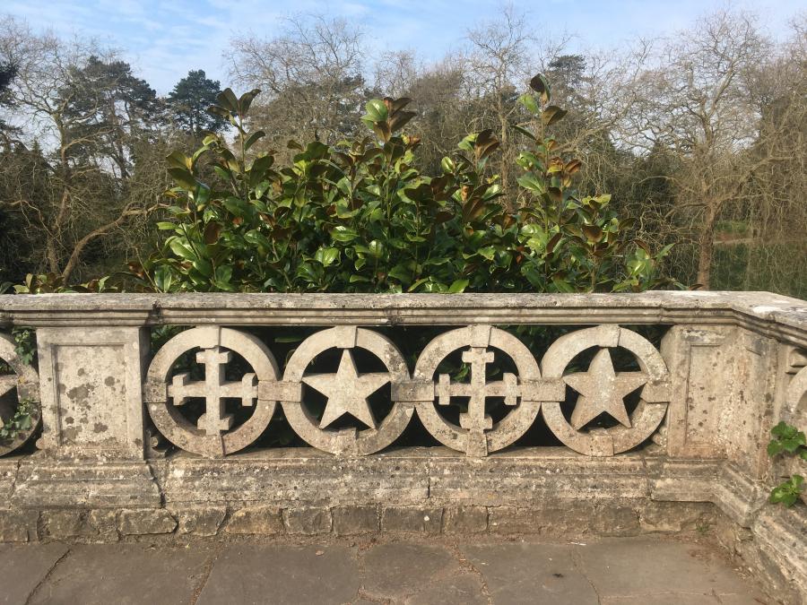 Stone balustrades with alternating cross and five-pointed star shapes. 