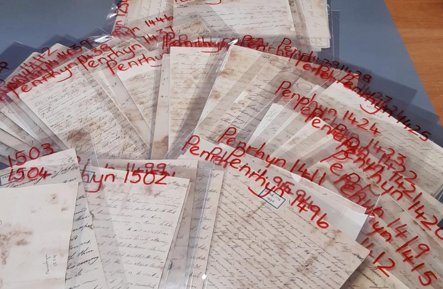 Lots of old letters laid out on a table