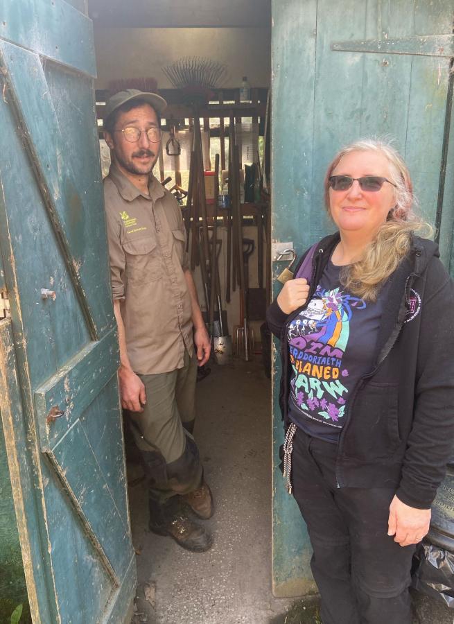 Photograph of two people stood in a doorway