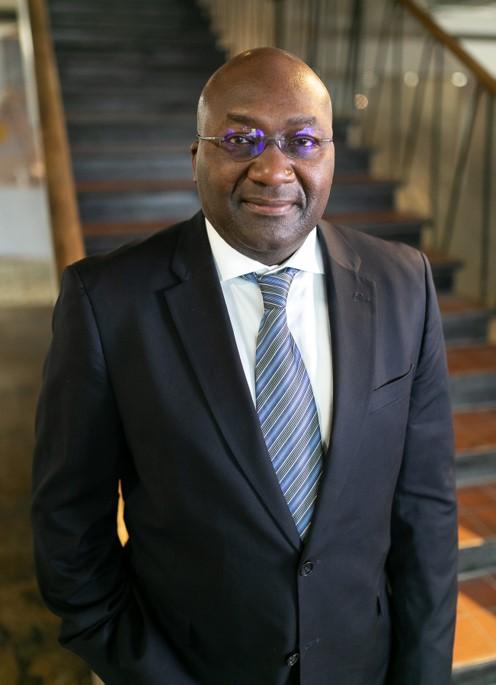 Photograph of Peter Waziri in a suit
