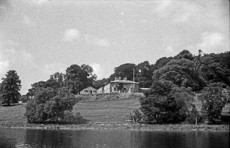 Photograph of a house at the edge of a lake