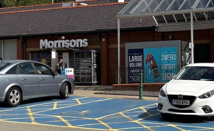 Parking space surrounded by two cars