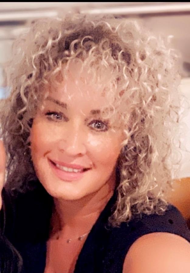 Woman with Curly Blonde Hair Smiling 