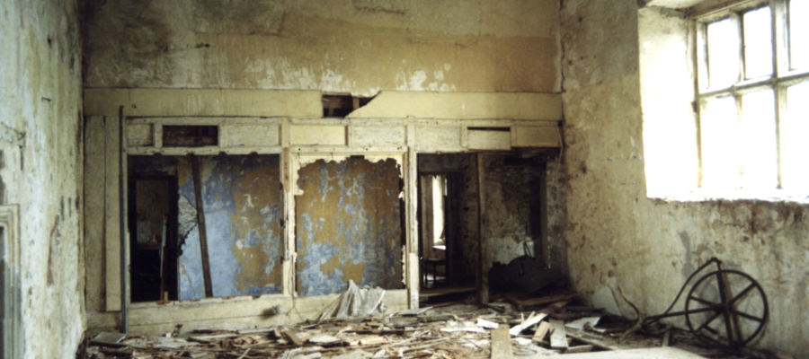 Photograph of a derelict room. 