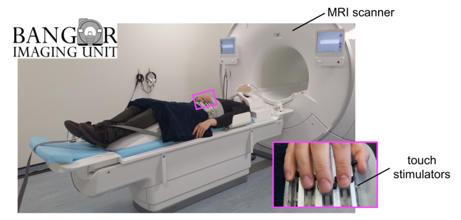 A person lying on an MRI scanner