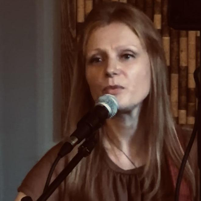 Laura Wainwright behind a microphone
