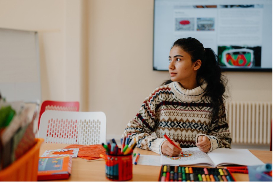 image of a girl colouring in a classroom